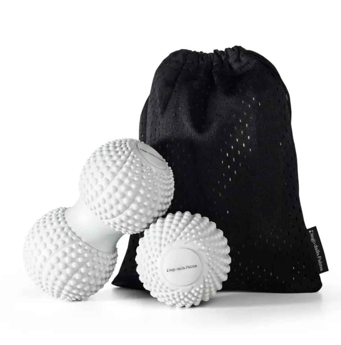 Three white textured massage balls with a black drawstring pouch, photographed on a clean white background.