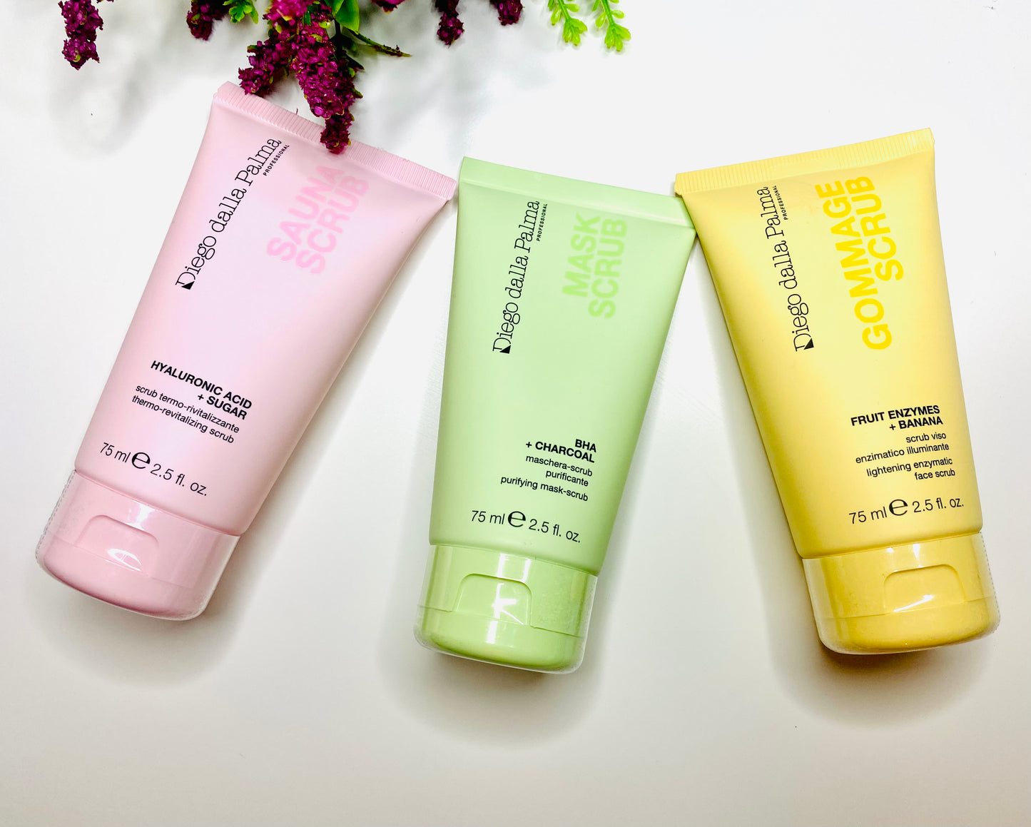 Image of DDP Hyaluronic Acid Scrub and Thermo-Revitalizing Mask 75 ml Limited Edition, DDP Purifying Charcoal and BHA Scrub 75 ml Limited Edition and DDP Fruit Enzymes and Banana Scrub 75ml Limited Edition lined up in a row